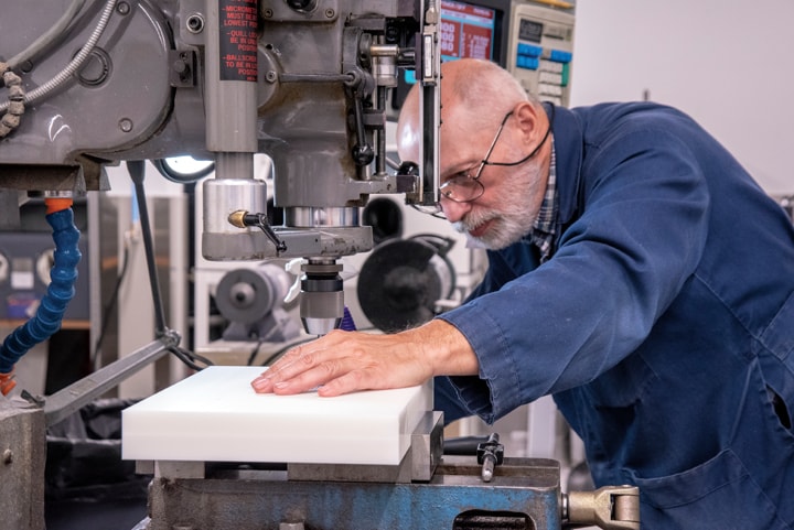 PTI Employee mans a drill press