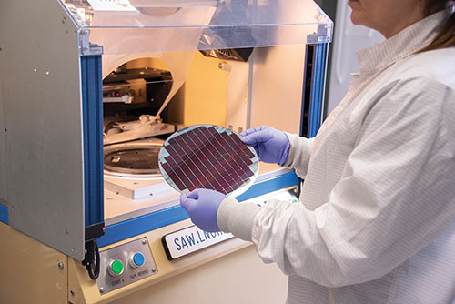 Lead technician Angela Espinosa prepares a wafer full of microdisplays for eMagin’s packaging process.