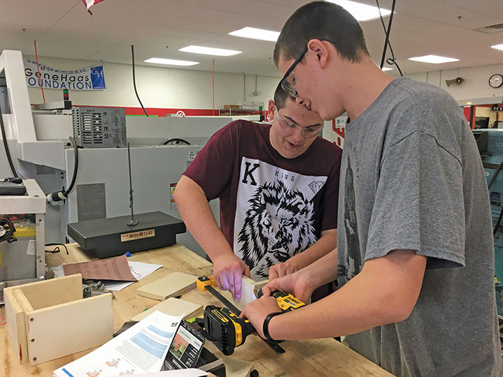 Young scholars Brandon Pendell and Travis Boice work together to construct the bumpers for the robot.