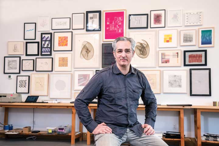 Bre Pettis in front of his historic computer plotter art collection