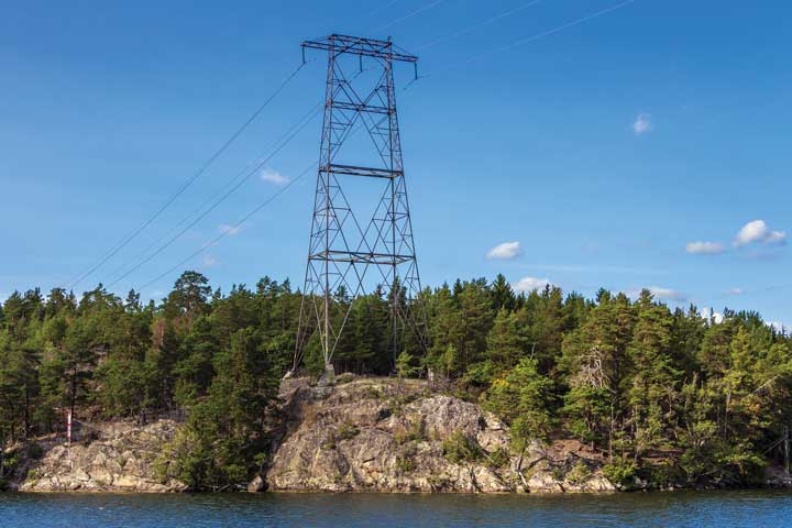 Electric Pylon on Rock Shoreline